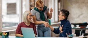 Intern shaking hands with a smiling colleague, representing inclusion, onboarding, and the beginning of a meaningful career path.