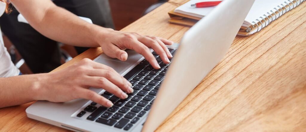 Person using a laptop to complete an online training course