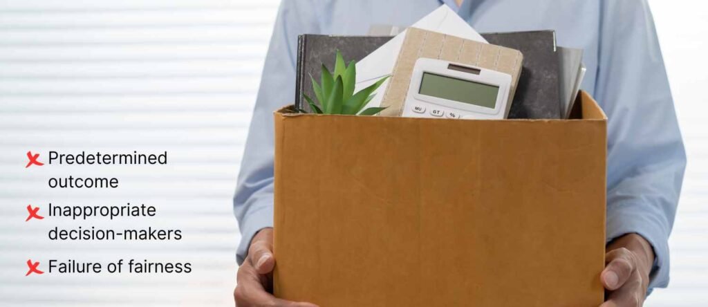 Male employee holding a cardboard box of personal items walking out of office after being dismissed.