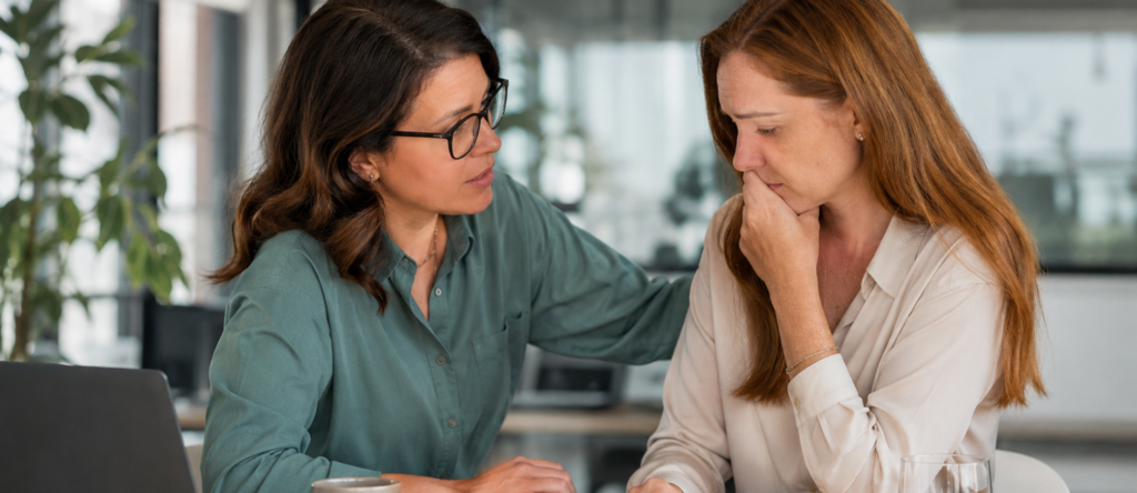 Employee having a confidential workplace conversation with a manager about a serious concern