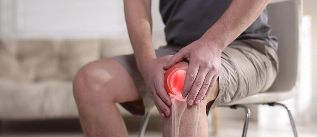 Employee experiencing knee pain, highlighting sickness absence and the importance of exploring alternatives to dismissal in the workplace.